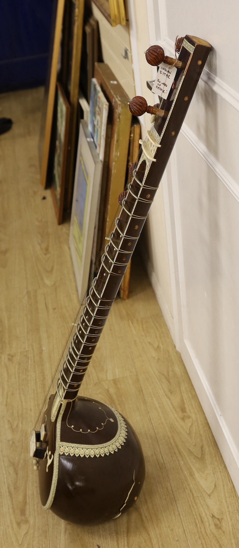 An Indian Sitar (in need of repair) with hard case, 123cms high.